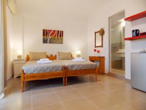 a bedroom with a bed with two towels on it at ERA Studios2 in Skiathos