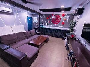 a living room with a couch and a table at Sea Love Homestay Pulau Ketam in Bagan Teochew