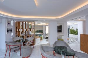 a living room with chairs and a table at Iraklion Hotel in Heraklio