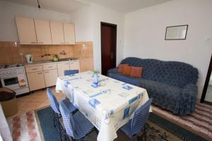 a living room with a table and a couch at Apartments Ruzinka in Podaca +37 photos