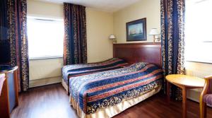 Postel nebo postele na pokoji v ubytování Quality Hotel Grand Steinkjer