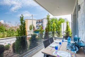 a patio with a table and chairs on a balcony at Valeri luxury stone deluxe apartment in Hanioti