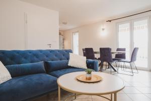 a living room with a blue couch and a table at Villa Nika in Klimno