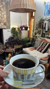 a cup of coffee on a plate on a table at CasaEstudio in El Chalten