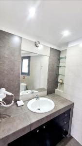 a bathroom with a sink and a mirror at Villa Serafeim in Kymi