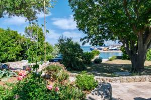 a garden with a view of the water at Villa EVITA with sea view in Nerezine