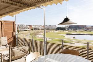 a balcony with a view of a golf course at Emporda Golf 30 2-1 in Gualta