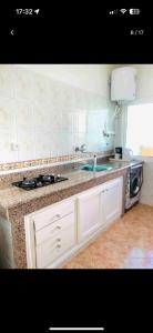 a kitchen with a sink and a microwave at Appartement Rabat Océan in Rabat