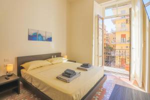 a bedroom with a bed and a large window at B&B Salerno Centrale in Salerno