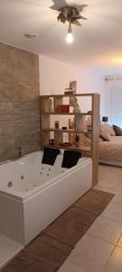 a bath tub in a room with a bed at Villa Semaphore in Salin-de-Giraud