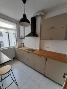 a kitchen with a wooden counter top in a room at Ático completamente equipado Plaza de España in Ferrol