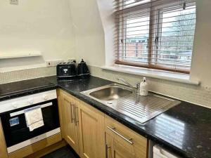a kitchen with a sink and a counter top at One Bed Apartment- Muswell Hill in London