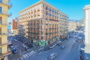 an overhead view of a street with a large building at B&B Salerno Centrale in Salerno