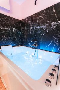 een badkamer met een bad gevuld met water bij Capsule cloud - jacuzzi - projecteur cinema in Tourcoing