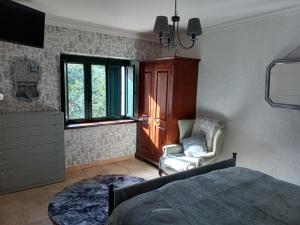 a bedroom with a bed and a chair and a window at Apartment in Gallinaro with stunning views in Gallinaro