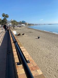 a view of a beach with a black pipe at Biznaga Hols in Benalmádena