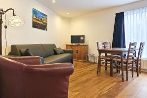 a living room with a couch and a table at Vakantiewoning Veere VE01 in Veere