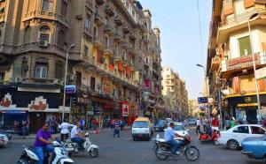 a group of people riding motorcycles on a busy city street at Cairo Paradise Hotel in Cairo