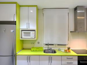 a kitchen with a sink and a microwave at Luminoso, con patio y buena zona in Madrid