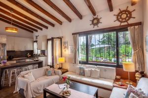 a living room with a couch and a table at The Gift Sani Villa in Sani Beach