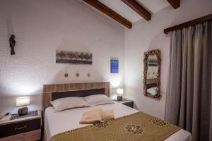 a bedroom with a large bed and a mirror at The Gift Sani Villa in Sani Beach