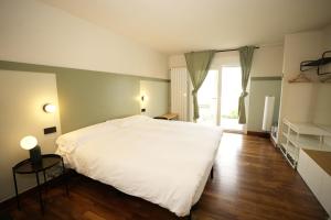 een slaapkamer met een wit bed en een groot raam bij Keyser Rooms in Sopelana