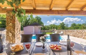a table with plates of food on top of a patio at Villa Patrick in Gostinjac