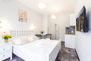 1 dormitorio blanco con 1 cama blanca en una habitación en Apartmány U zámku, en Český Krumlov