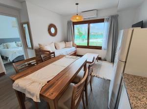 a kitchen and living room with a table and a couch at Chadel BuenaVid Cafayate in Cafayate
