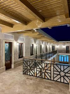 a large room with a pool and a wooden ceiling at Antique Hotel Rizvan in Bukhara