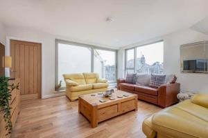 a living room with two couches and a coffee table at Argyle Rigg * Deluxe Central Townhouse * Balcony in St Andrews