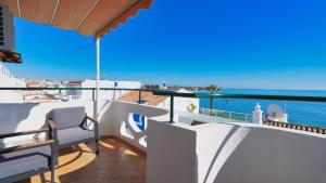 a balcony with chairs and a view of the ocean at Guest House Dianamar in Albufeira