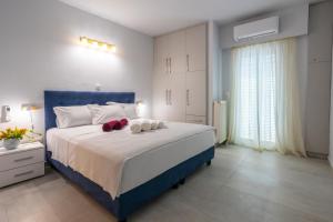 a bedroom with a blue bed with towels on it at Casa George in Rethymno Town