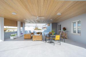 a patio with a wooden ceiling and a table and chairs at Casa George in Rethymno Town