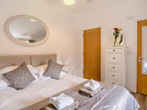 a bedroom with a bed with a mirror on the wall at 4 Bed in Newport 90251 in Newport