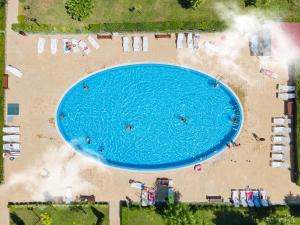 an overhead view of a large swimming pool on a beach at Holiday and Orchid Fort Noks Apartments in Sunny Beach