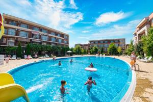 a group of people playing in a swimming pool at Holiday and Orchid Fort Noks Apartments in Sunny Beach