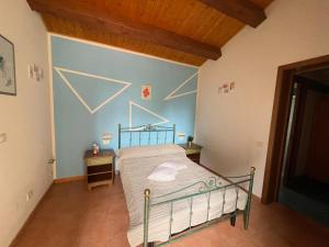ベルティノーロにあるFattoria Paradisoの青い壁のベッドルーム1室(ベッド1台付)