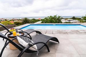 a patio with chairs and a swimming pool at Sunrise on Gazelle in Jeffreys Bay