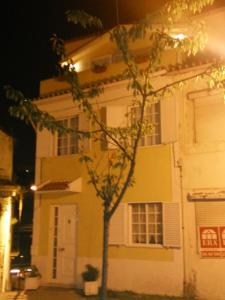 Una casa amarilla con un árbol delante. en Sailor's House - Holiday's House en Oporto