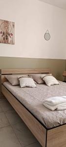 a bed with white pillows on it in a room at Villa Semaphore in Salin-de-Giraud