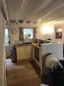 a kitchen with a sink and a stove top oven at Castlegate Cottage in Pickering +9 photos