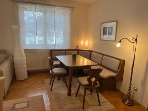 uma sala de estar com uma mesa e cadeiras e um sofá em IV Gemütliche Ferienwohnung in Pool-Position em Sankt Michael ob Bleiburg