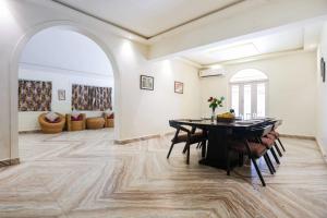 a dining room with a table and chairs at 6 BedRooms Nr Majorda Beach with pool in Majorda