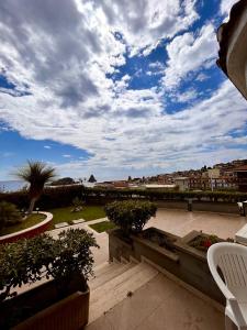 a patio with a view of the ocean under a cloudy sky at Hotel Lachea in Acitrezza