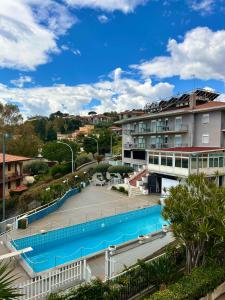 a view of a swimming pool in a city at Hotel Lachea in Acitrezza +28 photos