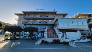 a building with a staircase in front of it at Hotel Lachea in Acitrezza