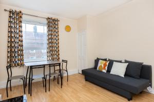 a living room with a couch and a table at Peaceful 1BR in Vibrant South Bank, 7min Borough in London