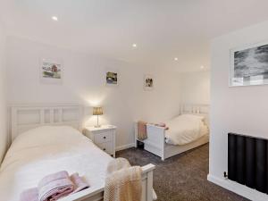 a small bedroom with two beds and a tv at 3 bed in Teignmouth 91466 in Teignmouth