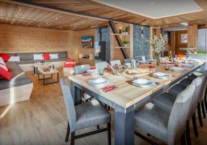 uma sala de jantar com uma mesa longa e cadeiras em Chalet Guimauve - Les Congères em Manigod